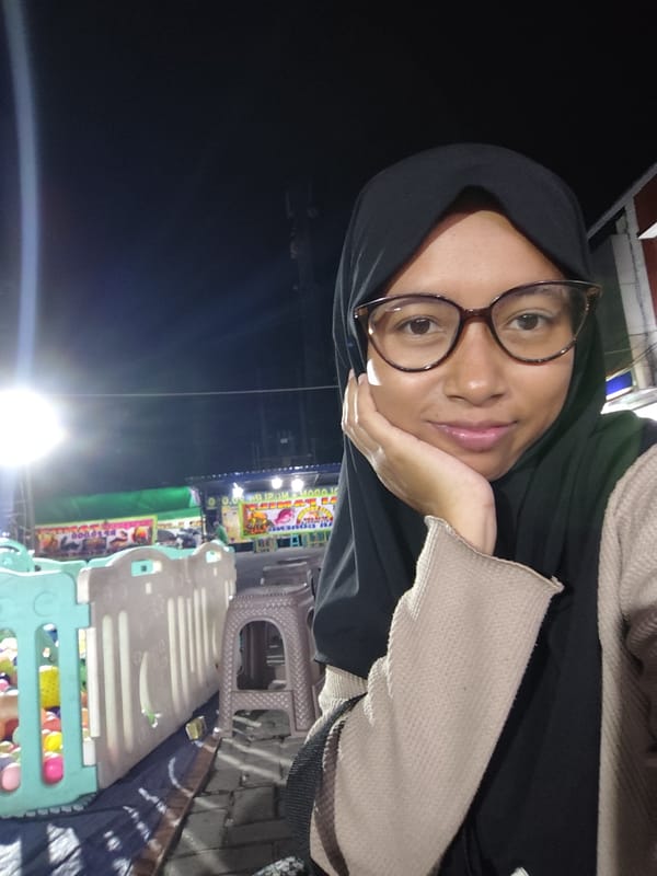 Evening at an outdoor market with rides, games, and food