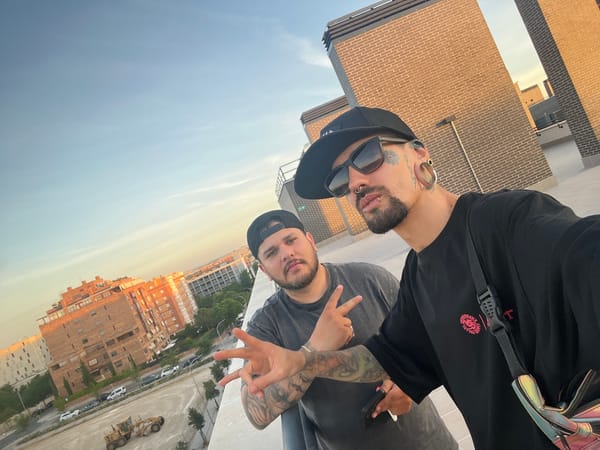 Tattooed individual photographs Madrid sunset from rooftop balcony