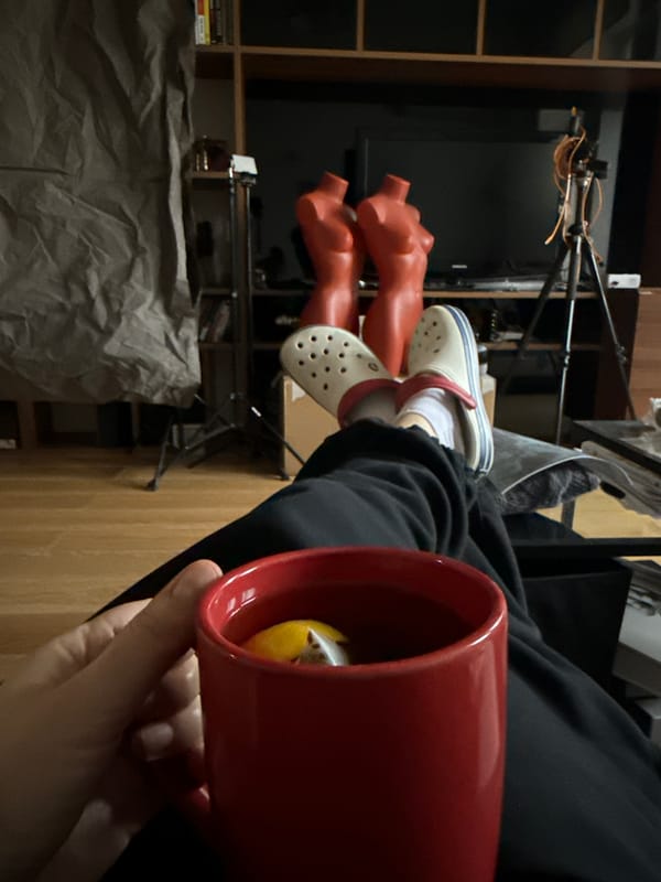 Person relaxes with tea amid mannequins in Moscow apartment