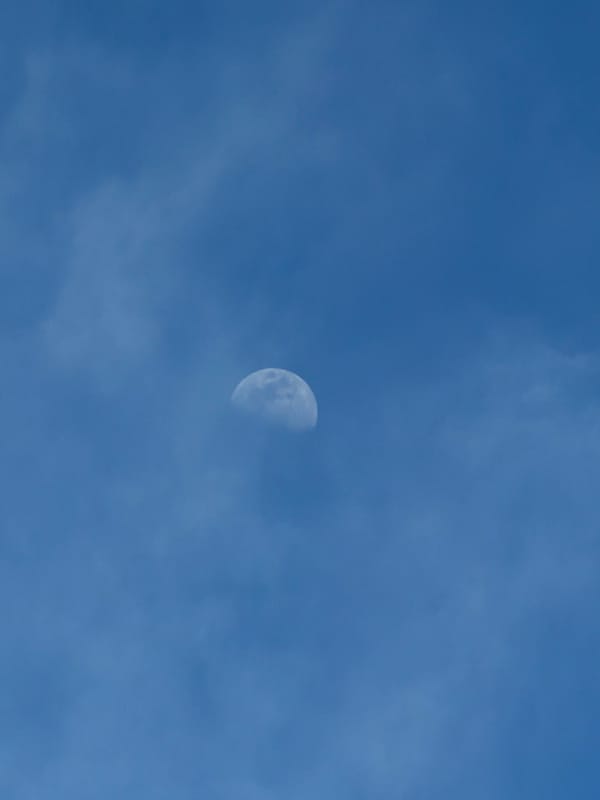 Daytime moon spotted over Velingrad, Bulgaria on clear afternoon
