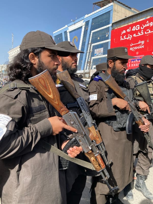 Armed uniformed personnel patrol Kandahar streets in formation