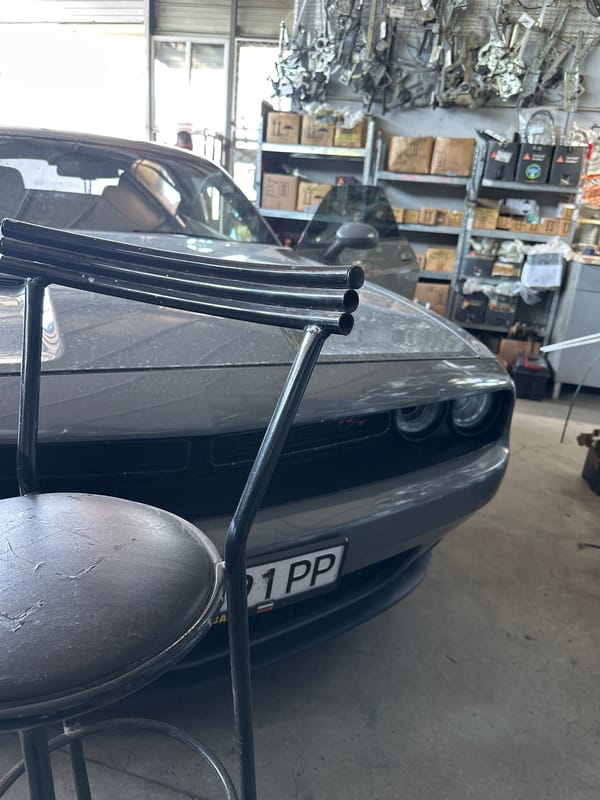 Gray Dodge Challenger in garage from multiple angles