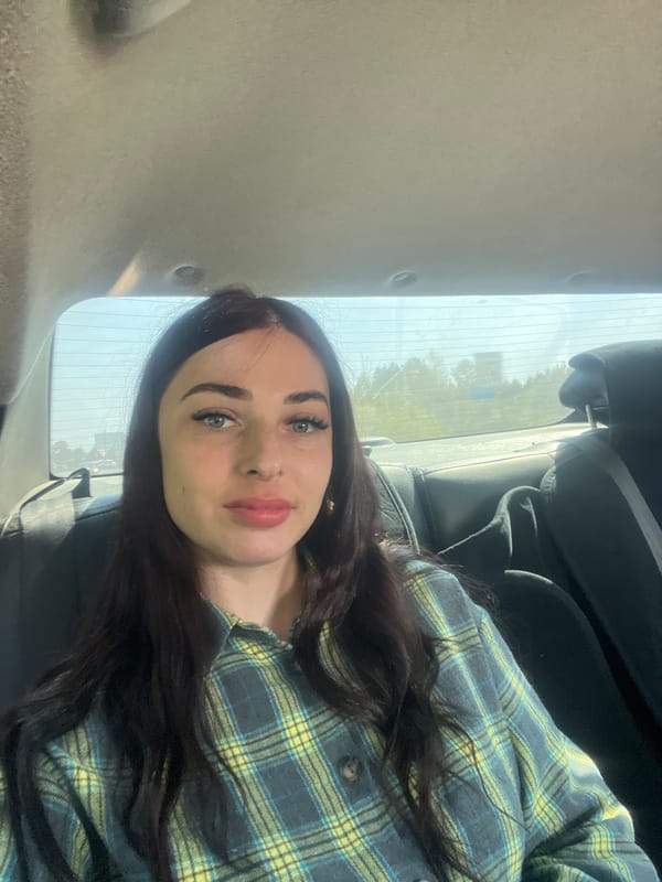 Woman photographed in car wearing ripped jeans in Chaikovsky