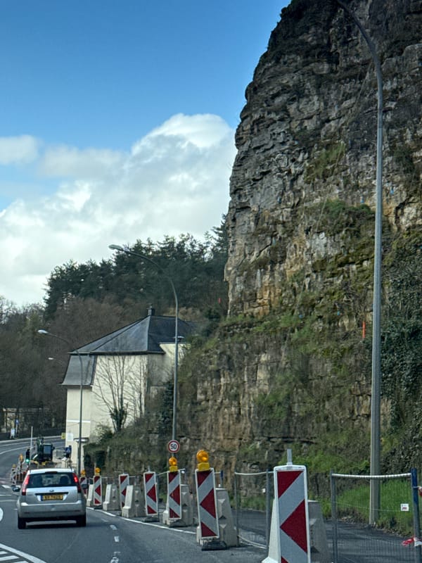 Morning jogger shares road with construction traffic in Luxembourg
