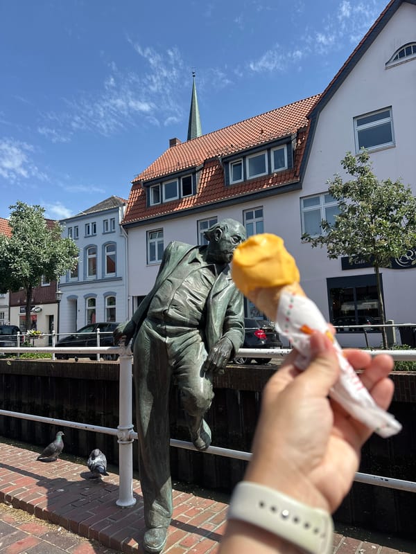 Playful ice cream offering to bronze statue in Buxtehude