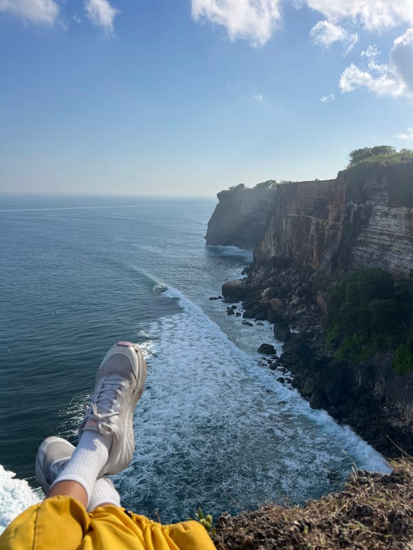 Feet up on a cliff edge in Kuta Selatan