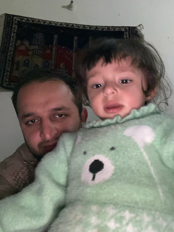 Father and child share tender moments in Kandahar home