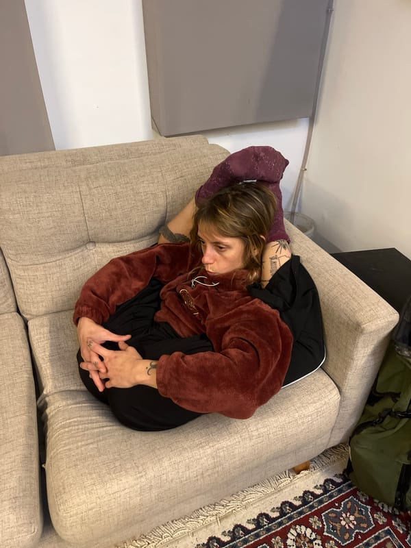 Person rests curled up on couch in La Lucila
