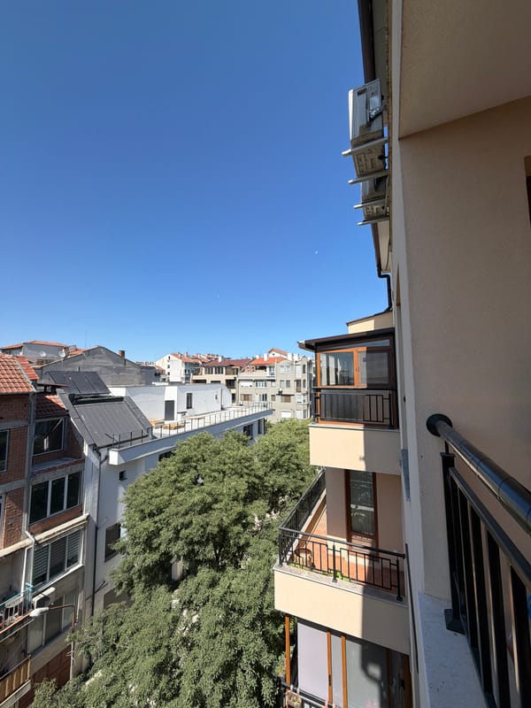 Balcony afternoon in Burgas: sun, seagulls, and an iced drink