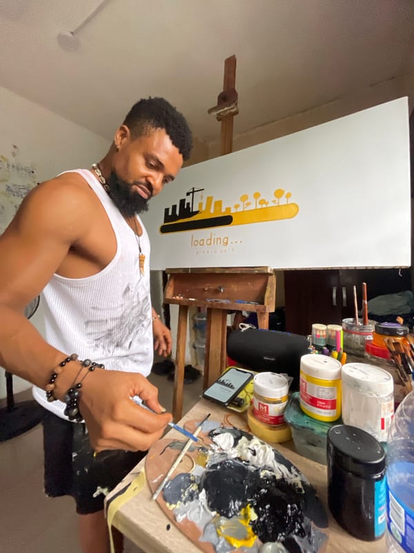 Artist paints on canvas in Ado, Nigeria studio