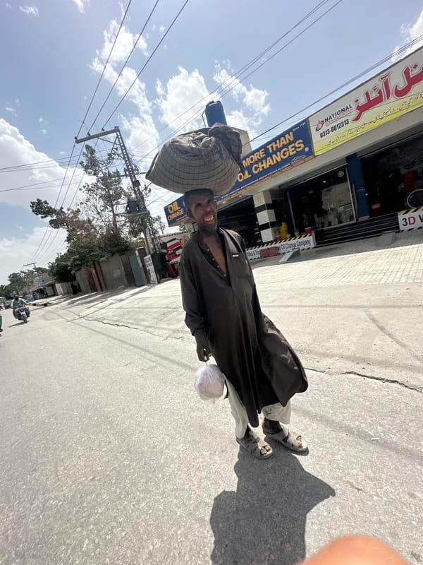 Man with traditional basket observed on Quetta sidewalk