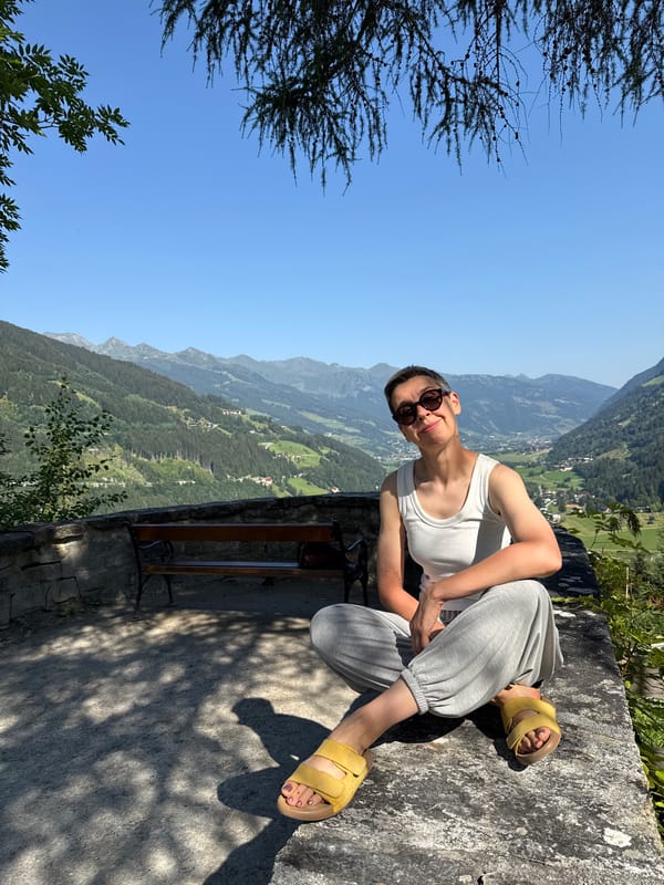 Relaxing on a stone ledge with Austrian mountain valley views