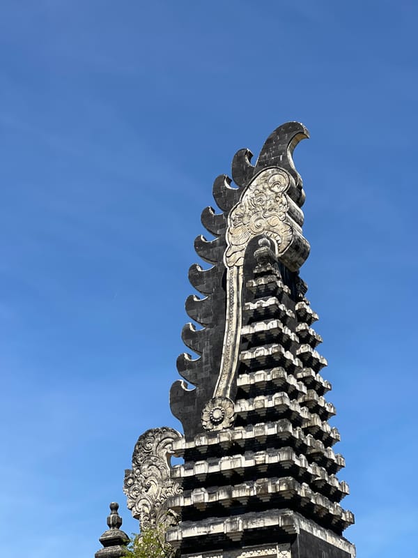 Balinese temple gate and open road, Denpasar midday