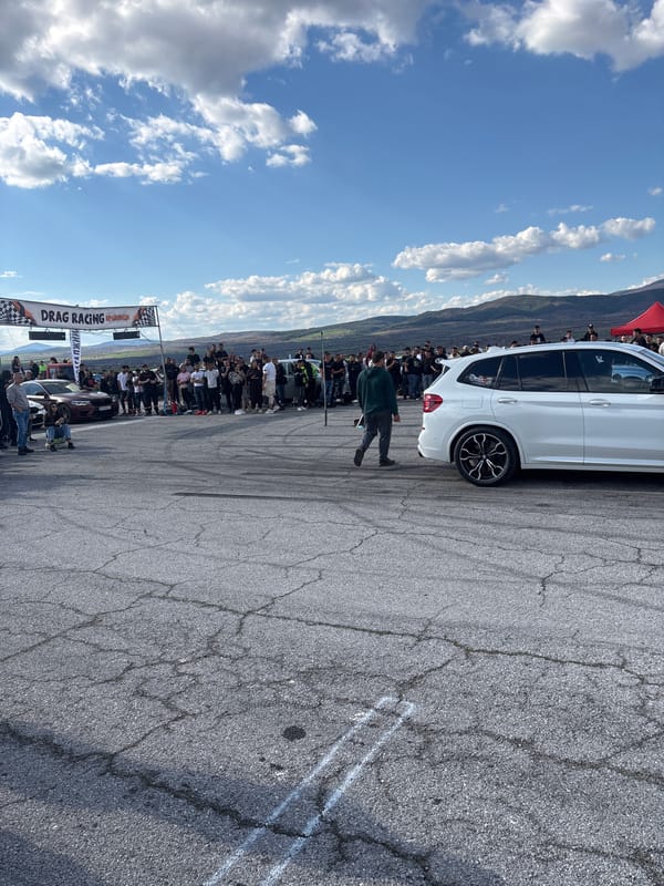 Crowd gathers on tire stacks to watch roadway event