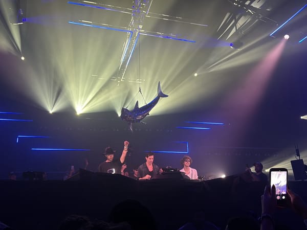 Concert features four performers with suspended metallic shark prop