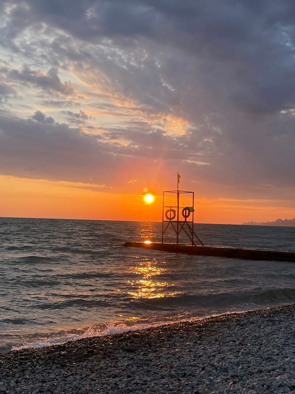 Sunset captured on Sochi pebble beach by beachgoer