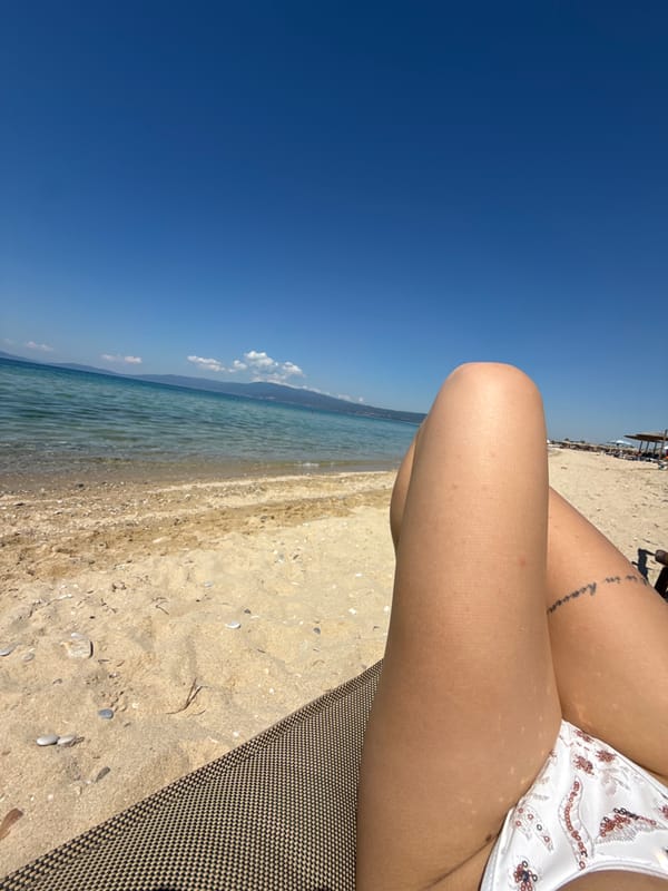 Woman relaxes in white bikini on beach chair