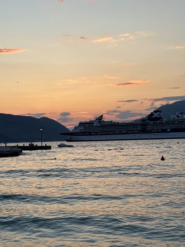 Celebrity Constellation at anchor during a vivid coastal sunset