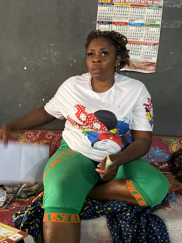 Counting cash and writing notes in a Nkpor home