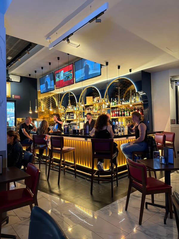 Patrons drink and socialize at Milan bar Friday afternoon