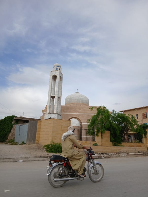 Motorcyclist photographed on street near mosque in Quetta