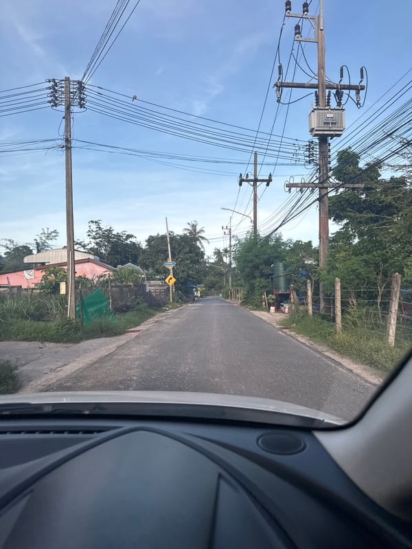 Vehicle journey documented through roadside scenes in Rawai, Thailand