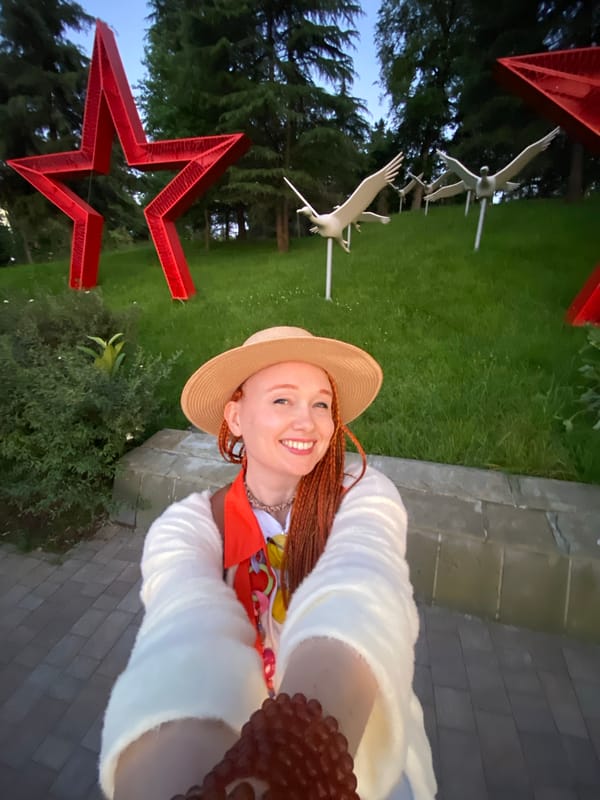 Woman takes selfies among roses in Sochi park