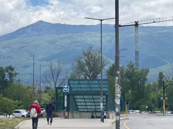 Pedestrians walk past Sofia metro station entrance