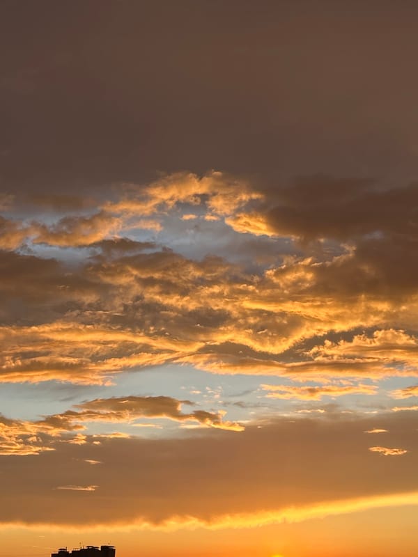 Vivid sunset colors over Pushkino rooftops on a June evening