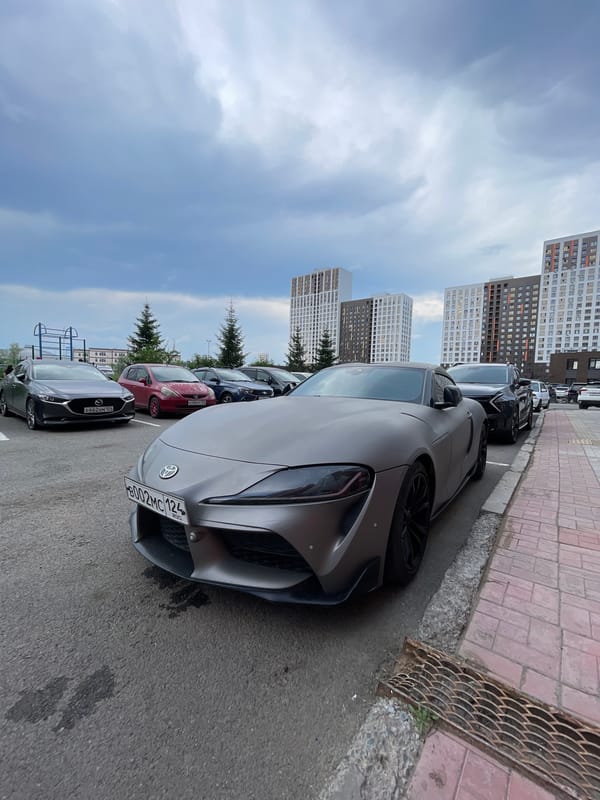 Matte gray Toyota Supra parked in Krasnoyarsk residential area