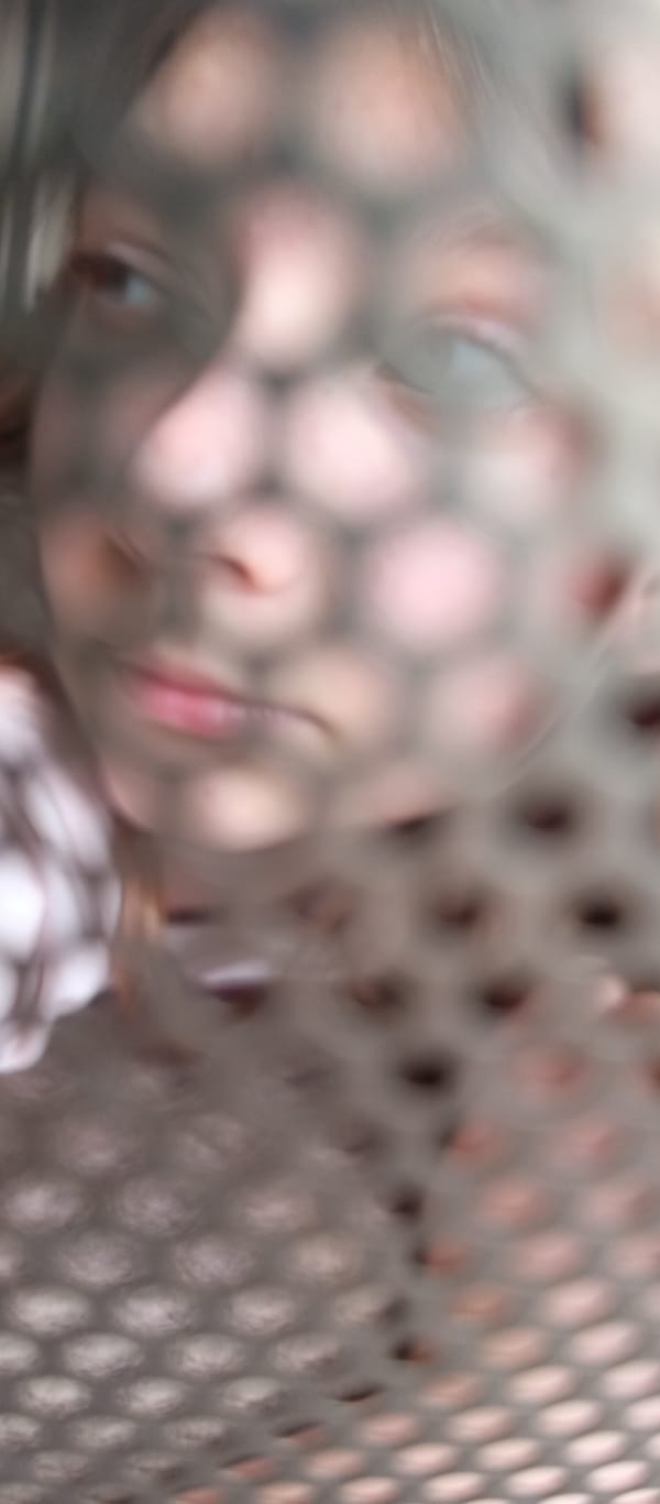 Person photographed through screens and mirrors in fragmented portraits