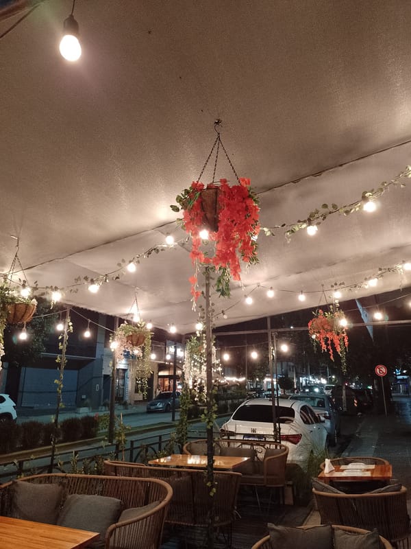 Nighttime scenes captured in Quilmes: restaurant patio and motorcycle shop