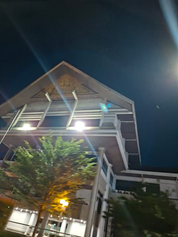 Ornate triangular building photographed at night in Lhokseumawe