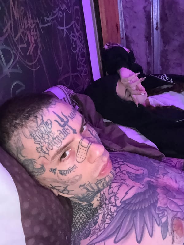 Tattooed individual rests indoors in Buenos Aires early morning