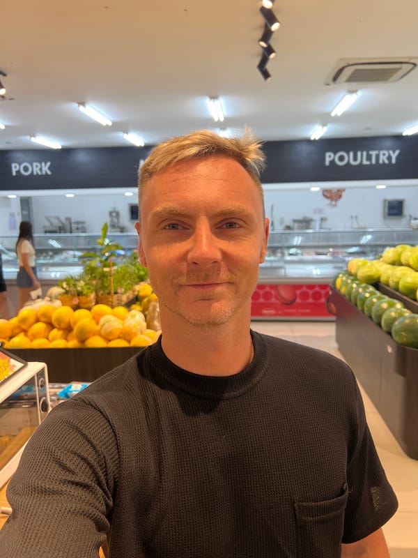 Selfies in a North Kuta grocery store, produce aisle nearby