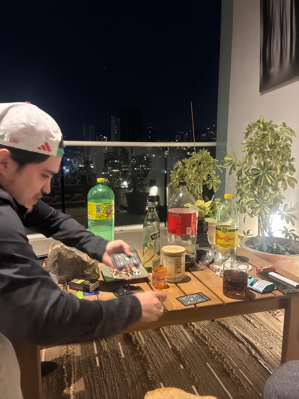 Man with cards at table during nighttime indoor scene