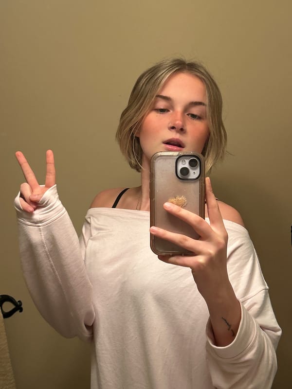 Woman takes selfie in Whistler, makes peace sign