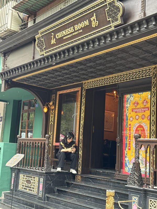 Person sits outside ornate cocktail bar in Jinjiang District