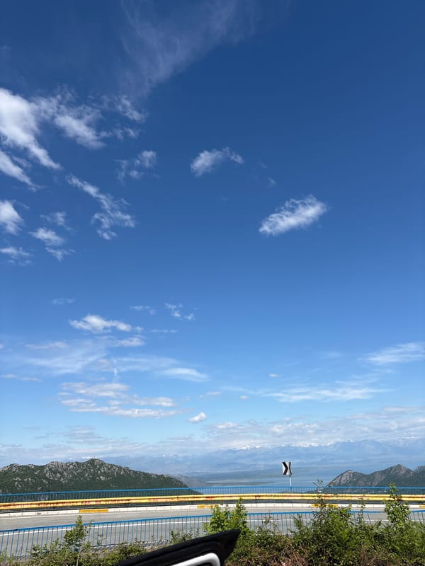 Clear blue sky with scattered clouds observed outdoors