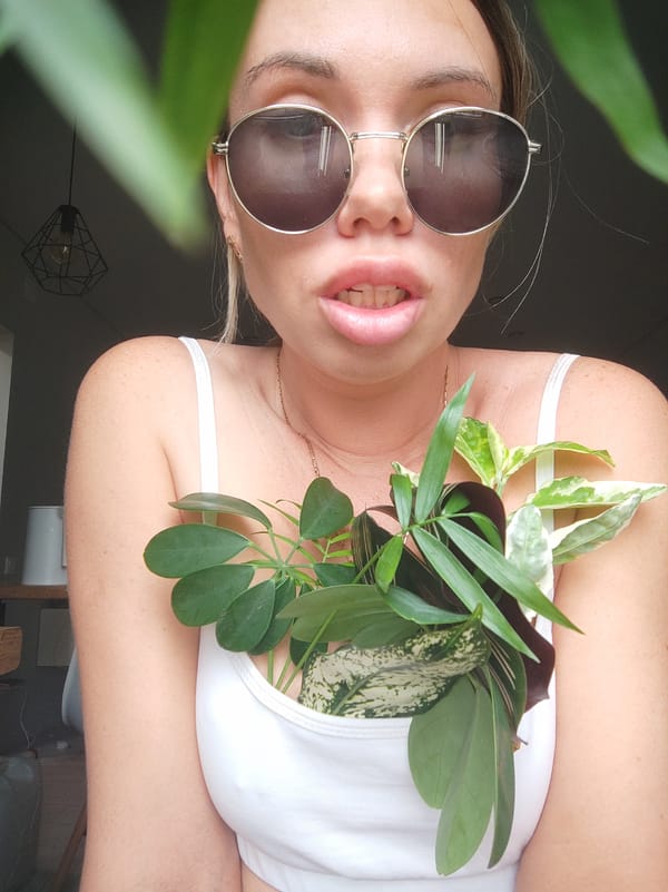 Woman poses with plants, accessories in Votkinsk photo session