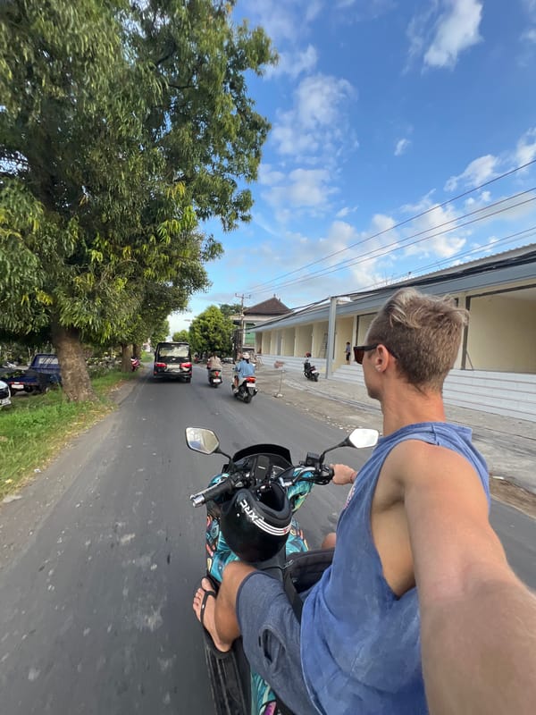Motorcyclist takes selfie while riding through Ubud streets