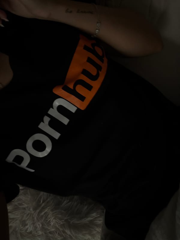Person in branded t-shirt resting indoors in Sofia