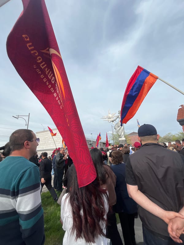 Crowd gathers with Armenian flags near Mother Armenia statue