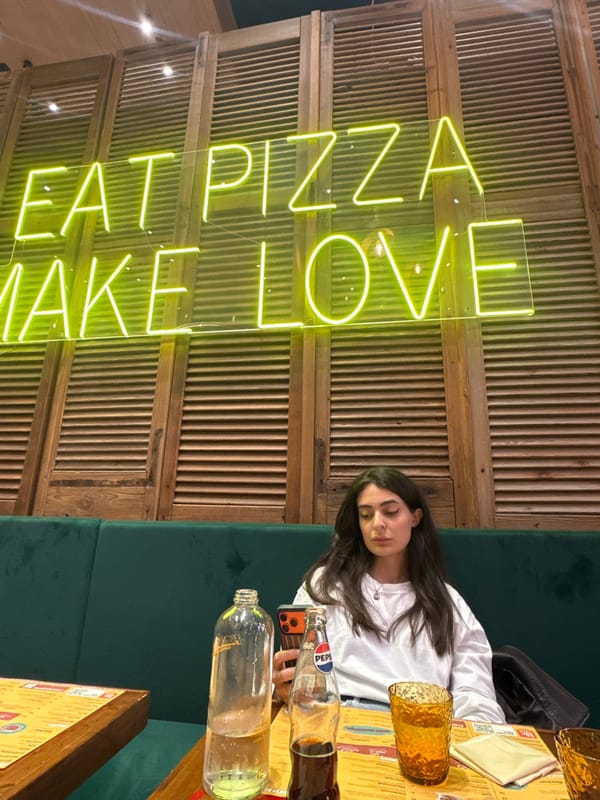 Woman rests at Milan pizza restaurant during evening dining