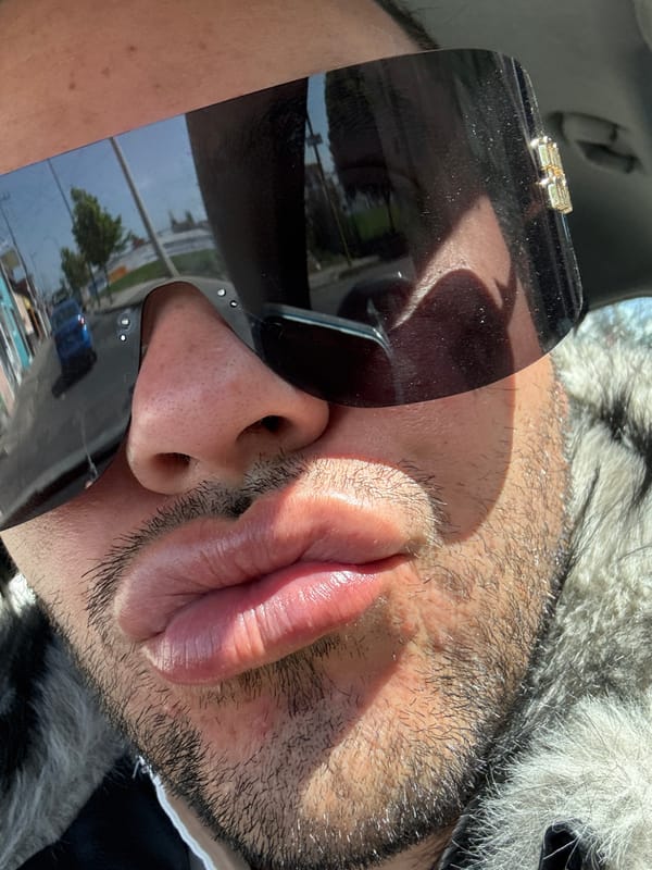 Man in sunglasses and fur jacket photographed in vehicle