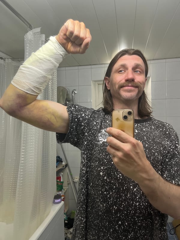 Man Takes Mirror Selfie in Bathroom Wearing Patterned Shirt