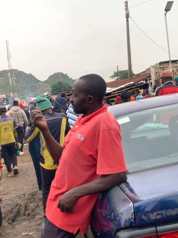 Gura Top market buzzing with vendors and produce on a rainy morning