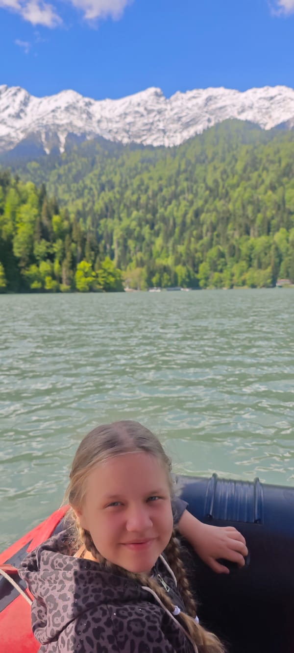 Families enjoy sunny paddle boat excursion on Abkhazian mountain lake