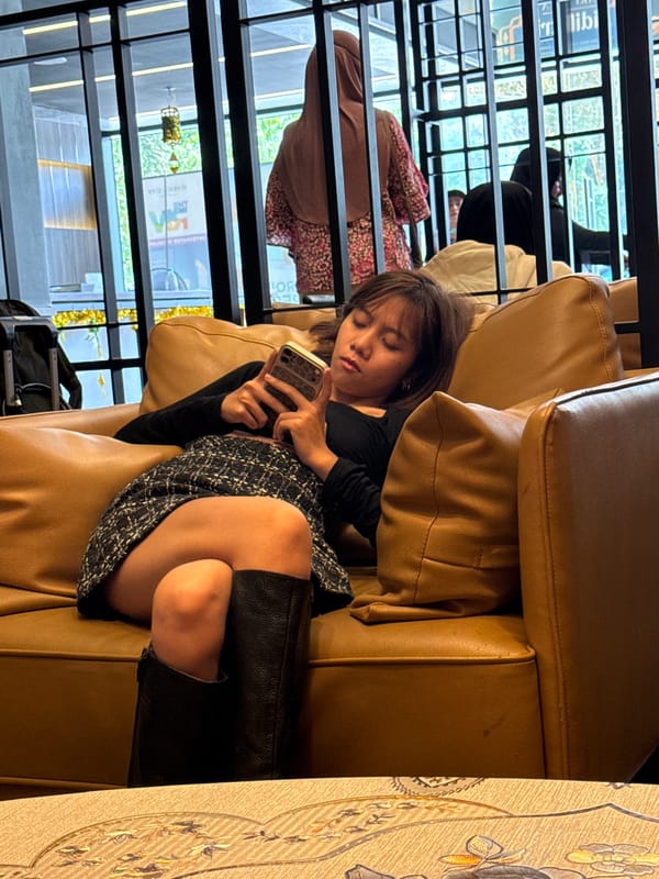 People gather in Kuala Lumpur lounge, use phones