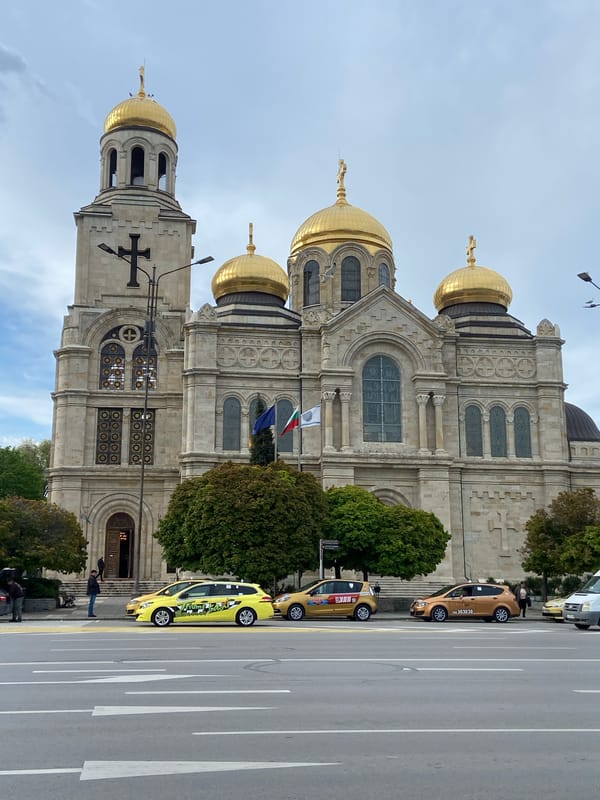 Street scenes documented in unidentified city, cathedral visible